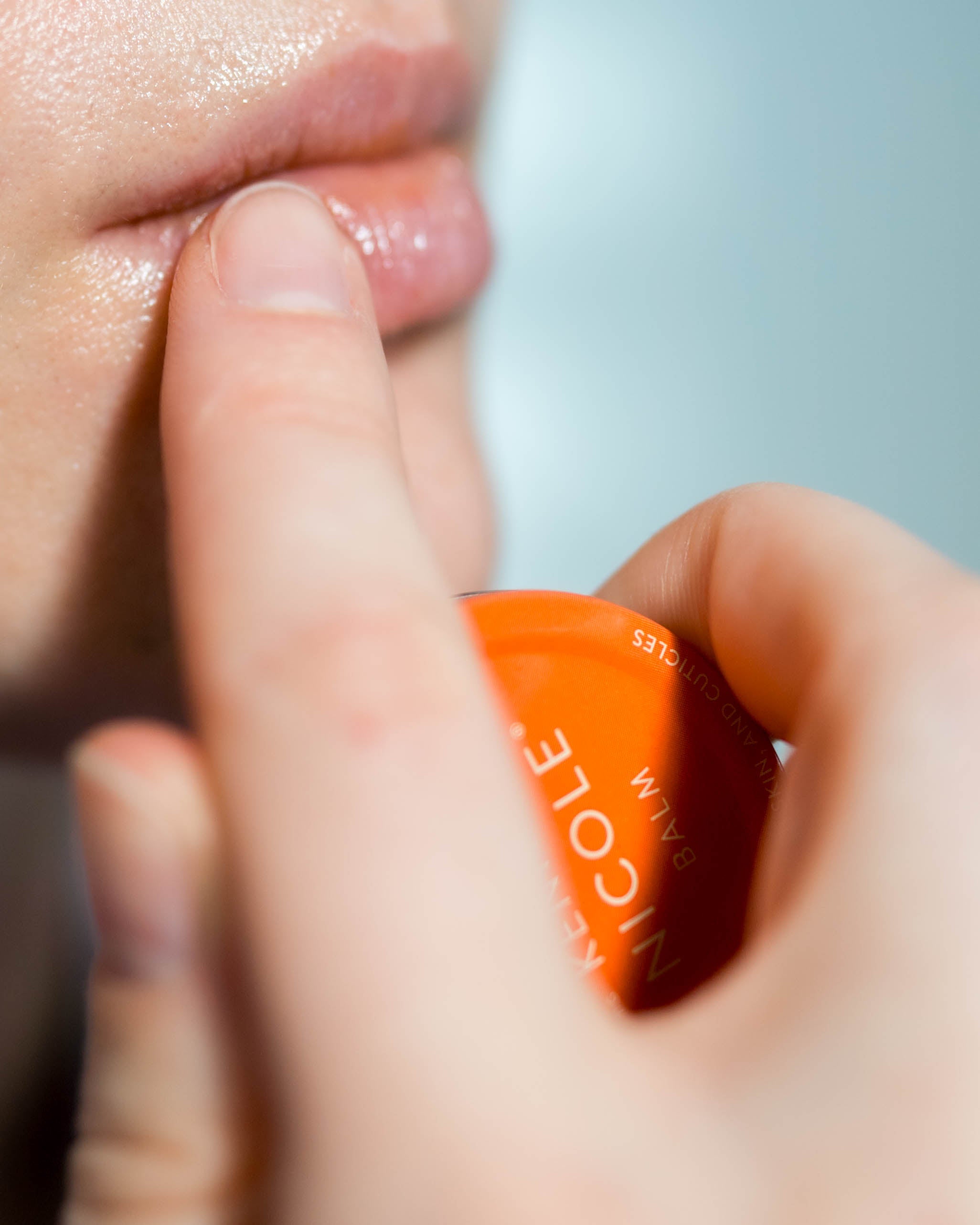 Close-up of a hand applying Kenna Nicole Balm