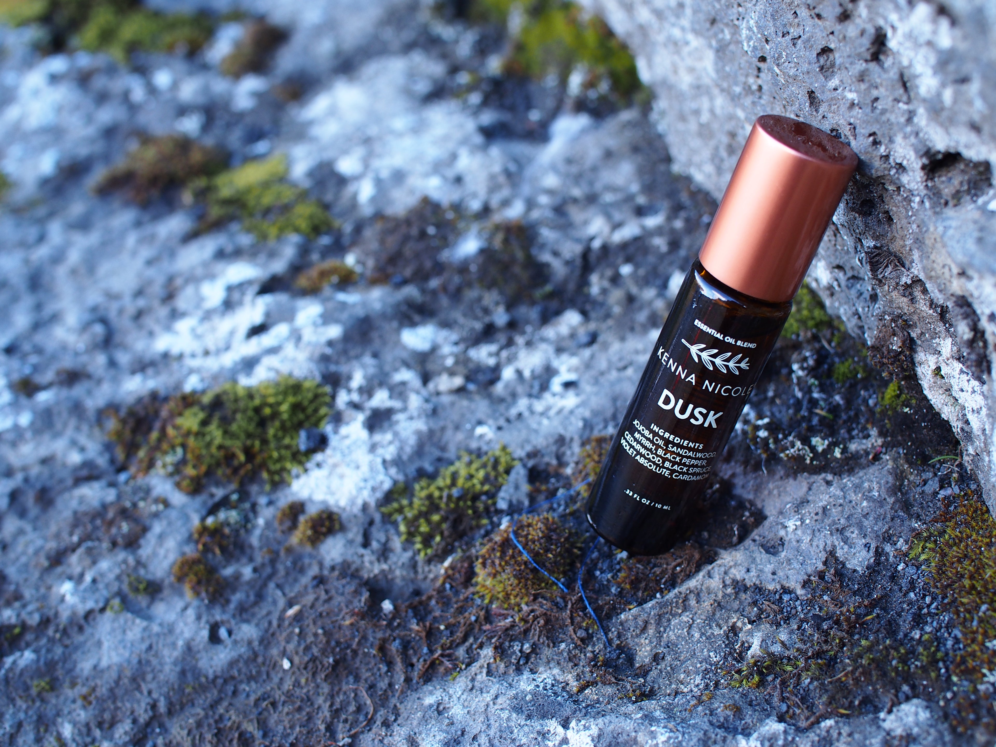 Kenna Nicole's Dusk on a rocky surface with visible branding