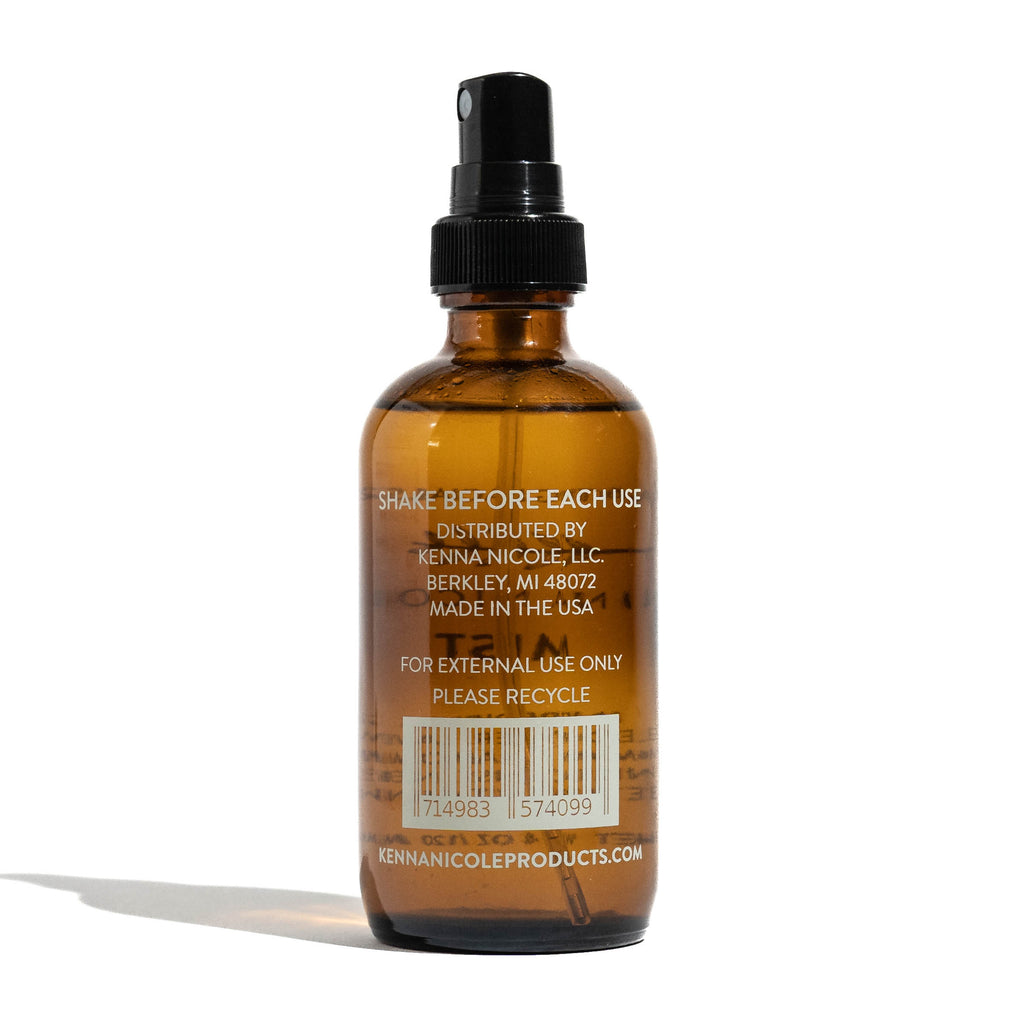 Brown glass bottle with black spray nozzle on a white background